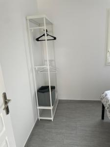 a white cabinet in a corner of a room at Appartement t2 avec terrasse et cour in Cavaillon