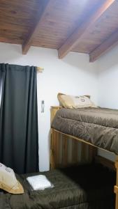 a room with two bunk beds and a window at House Las Heras in Las Heras