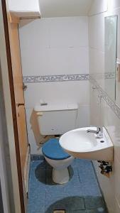 a bathroom with a toilet and a sink at House Las Heras in Las Heras