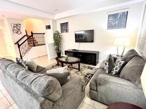 a living room with a couch and a table at Cozy Family Town Home Close to Disney townhouse in Kissimmee