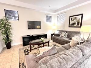 a living room with a couch and a tv at Cozy Family Town Home Close to Disney townhouse in Kissimmee