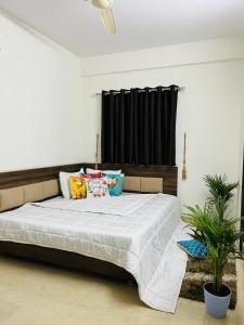 a bedroom with a large bed with pillows on it at DivBnK homes Bangalore in Bangalore