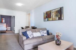 sala de estar con sofá y mesa en Skyline Sanctuary 1BR Apartment with River Views, en Brisbane