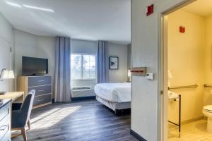 a hotel room with a bed and a window at Candlewood Suites New Bern by IHG in New Bern +30 photos
