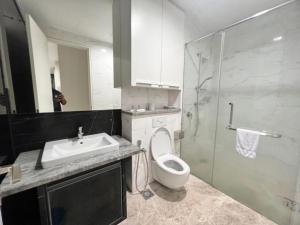 a bathroom with a toilet and a sink and a shower at The Platinum Serviced Suites by Faced in Kuala Lumpur