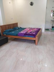 a bed in a room with a purple mattress at New greens inn in Yelagiri