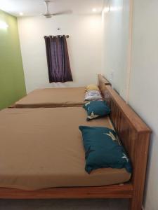 two beds sitting next to each other in a room at New greens inn in Yelagiri