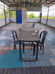 a wooden table and chairs on a patio at New greens inn in Yelagiri