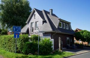 a house with a blue sign in front of it at Ferienhaus Celeste in Warnemünde