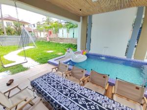 a swimming pool with a table and chairs next to a pool at Luxpro Luxury Villa / Seremban 2 / Private Swimming Pool in Seremban