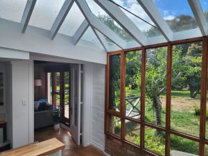 an extension to a house with glass doors and windows at Daylesford - FROG HOLLOW ESTATE - One bedroom Homestead Villa - book for 3 nights pay for 2 - contact us for more details in Daylesford