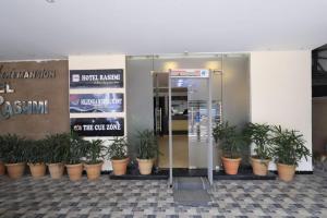 a group of potted plants in front of a store at Hotel Rashmi Guwahati in Guwahati