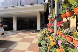 a building with lots of plants and flowers at Hotel Rashmi Guwahati in Guwahati