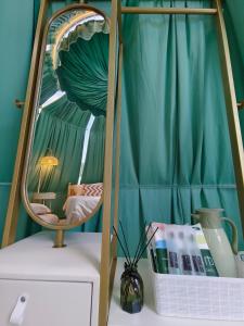 a mirror sitting on top of a dresser in a room at The Starry Dome in Cameron Highlands