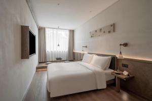 TV a/nebo společenská místnost v ubytování Sahe Hotel Shanghai World Expo