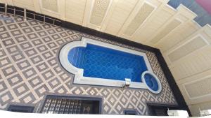 a swimming pool on the wall of a building at The Afrosiyob Ok in Samarkand