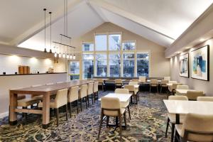 a dining room with a long table and chairs at Residence Inn Salt Lake City Cottonwood in Cottonwood Heights