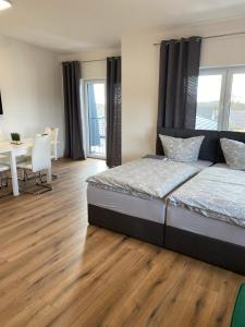 a bedroom with a bed and a wooden floor at Bruchersee 4 oberbergisches Land in Marienheide