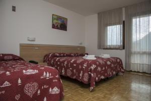 Postel nebo postele na pokoji v ubytování Hotel Cima Tosa