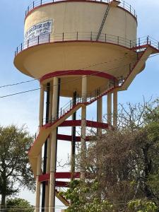 a large water tower with a person on it at SRIRAM HOMESTAY 01 KM to SRI RAM MANDIR in Ayodhya +16 photos