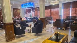 a lobby with a waiting room with chairs and tables at Mentokling Residency, Leh, Ladakh in Leh