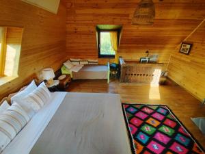 a living room with a large bed in a wooden room at Small Apartment in Breb s Cosy Barn in Breb