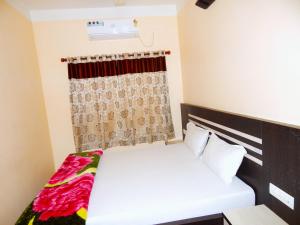 a bedroom with two beds and a window at Hotel PALKI Near Mandarmani Sea Beach in Mandarmoni