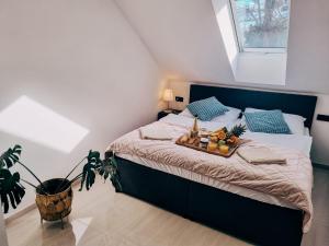a bedroom with a bed with a tray of fruit on it at Apartmány u Parku in Lednice