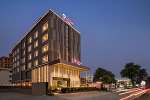 西里古里Ramada Encore by Wyndham Siliguri Sevoke Road的街道边有灯的建筑物