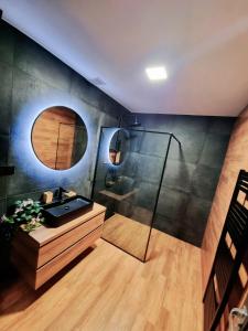 a bathroom with a shower with a sink and a mirror at Apartmány u Parku in Lednice