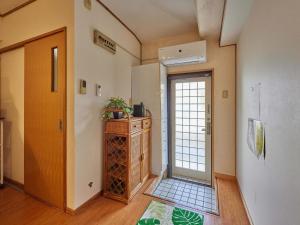 a hallway with a door leading to a room at Yukurina Resort Okinawa in Motobu