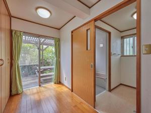 an empty room with a door and a window at Yukurina Resort Okinawa in Motobu