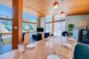 a dining room with a table with glasses on it at Hakuba Jade Chalet by Jade Group in Hakuba