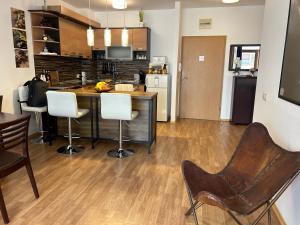 uma cozinha com um balcão e cadeiras num quarto em Edmond Apartment-Highspeed-Internet-Free! em Aheloy