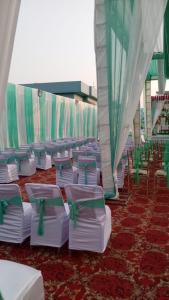 a row of chairs and tables in a tent at Hotel Royal Grand in Dehradun