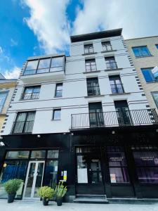 a white building with windows on a street at Hotel José in Blankenberge