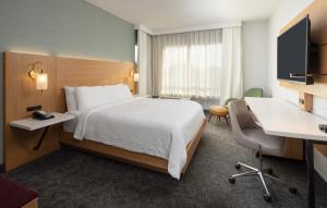 a hotel room with a bed and a desk at DoubleTree by Hilton Houston Westchase in Houston