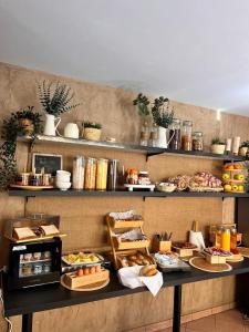 a buffet line with food on display in a restaurant at Hôtel Saint Pierre in Paris