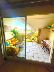 a living room with a view of a balcony at Appartement T2 La Saline Les Bains in Saint-Paul