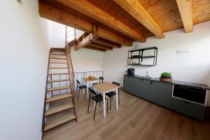 a kitchen with a spiral staircase and a table and chairs at Argenteria5 Holiday Rooms in Palermo