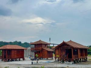 a couple of wooden huts sitting next to each other at HOMESTAY KAYU in Kajang