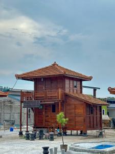 a large wooden house with a balcony on top at HOMESTAY KAYU in Kajang