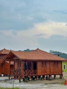 a large wooden building with a porch on it at HOMESTAY KAYU in Kajang