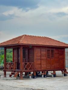 a small wooden building with a roof at HOMESTAY KAYU in Kajang