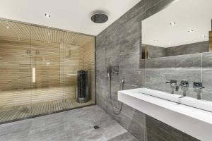 a bathroom with a sink and a shower at Résidence Fontany - Chalets pour 12 Personnes 044 in Les Allues