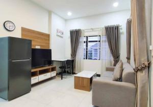 a living room with a couch and a television at LSP Hotel & Apartment in Phnom Penh