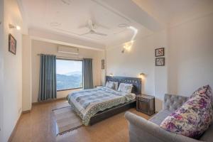 a bedroom with a bed and a couch and a window at 3 Br Harrington Villa Kitchen Living room AC in Kasauli