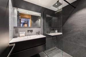 a bathroom with a sink and a mirror at Residence - Pièces 134 in Courchevel