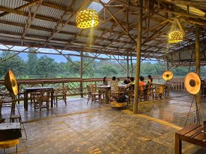 a group of people sitting at tables in a restaurant at Mount Kilimanjaro 360 view Cottage in Uru +60 photos