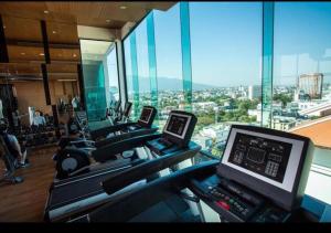 a gym with a view of a city from a building at The Astra Bozz Room in Chiang Mai